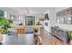 Bright living room with fireplace, hardwood floors, and stylish furnishings at 722 Eva Peak Dr, Erie, CO 80516