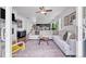 Open concept living area with large sofa, fireplace, and view into the kitchen at 722 Eva Peak Dr, Erie, CO 80516