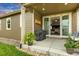 Covered back patio with string lights and sliding glass doors to the living area at 722 Eva Peak Dr, Erie, CO 80516