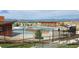 Community pool surrounded by a secure fence with mountain views beyond at 722 Eva Peak Dr, Erie, CO 80516