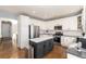 Modern kitchen with white cabinets, stainless steel appliances, and a large island at 10865 Cedar Brook St, Highlands Ranch, CO 80126