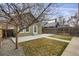 View of backyard with partial grass coverage, partial concrete coverage and a light-green home at 4017 King St, Denver, CO 80211