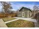 View of backyard with partial grass coverage, partial concrete coverage and a light-green home at 4017 King St, Denver, CO 80211