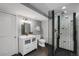 Modern bathroom featuring a glass enclosed shower, sleek vanity, stylish mirror, and contemporary finishes at 4017 King St, Denver, CO 80211