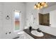 Renovated bathroom with updated fixtures, wainscoting, and stone countertop at 4017 King St, Denver, CO 80211