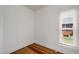 Empty room with bright window and hardwood floors at 4017 King St, Denver, CO 80211