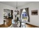 Bright dining room featuring hardwood floors, a modern light, and a view to the living room at 4017 King St, Denver, CO 80211
