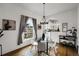 Charming dining area features a modern chandelier, hardwood floors, and abundant natural light at 4017 King St, Denver, CO 80211