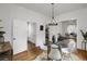 Dining room with hardwood floors, glass table, and views to other rooms creating a fluid feel at 4017 King St, Denver, CO 80211