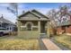 Charming bungalow with a brick facade, covered porch and well-manicured front lawn at 4017 King St, Denver, CO 80211