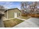 View of backyard with partial grass coverage, partial concrete coverage and a light-green garage at 4017 King St, Denver, CO 80211