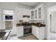 Beautifully-designed kitchen with white cabinets, tiled floors and stainless steel appliances at 4017 King St, Denver, CO 80211