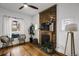 Bright living room showcasing hardwood floors and a classic brick fireplace, creating a warm atmosphere at 4017 King St, Denver, CO 80211