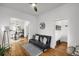 Open-concept area with hardwood floors and a dark leather sofa offering a view into the kitchen at 4017 King St, Denver, CO 80211