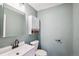 This powder bath features a decorative wall cabinet, modern sink faucet, and neutral paint at 68 N Quicksilver Ave, Castle Rock, CO 80104