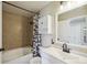 Cozy bathroom featuring shower with patterned curtain, sink and white cabinets at 68 N Quicksilver Ave, Castle Rock, CO 80104