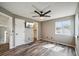 Bedroom featuring ceiling fan, closet access, mounted tv and wood-look flooring at 68 N Quicksilver Ave, Castle Rock, CO 80104