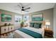 Cozy bedroom features natural light, neutral walls, a ceiling fan, and stylish decor at 68 N Quicksilver Ave, Castle Rock, CO 80104