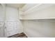Walk-in closet with custom shelving, storage drawers and wood-look flooring at 68 N Quicksilver Ave, Castle Rock, CO 80104