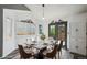 Dining room features an elegant table set with seating for six, modern decor, and bright natural light at 68 N Quicksilver Ave, Castle Rock, CO 80104