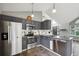 Kitchen featuring stainless steel appliances, modern cabinetry, a view of the living room, and ample counter space at 68 N Quicksilver Ave, Castle Rock, CO 80104