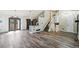 Open floor plan with stylish hardwood floors, staircase, leading into the kitchen area with grey cabinetry at 68 N Quicksilver Ave, Castle Rock, CO 80104