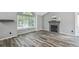 Cozy living room featuring a fireplace, large windows offering plenty of natural light, and hardwood floors at 68 N Quicksilver Ave, Castle Rock, CO 80104