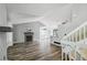 Bright and open living room with hardwood floors, fireplace, and stairs leading to the second floor at 68 N Quicksilver Ave, Castle Rock, CO 80104