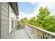 Balcony with white railings and mature green trees in view at 186 S 45Th Ave, Brighton, CO 80601