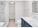 Sleek bathroom featuring a tiled shower, modern vanity, toilet, and a stylishly lit mirror at 186 S 45Th Ave, Brighton, CO 80601