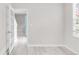 Bright bedroom featuring a large window, modern white paint and light wood-look flooring at 186 S 45Th Ave, Brighton, CO 80601