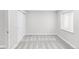 This bedroom has neutral carpeting and paint, bright natural light, and closet storage at 186 S 45Th Ave, Brighton, CO 80601
