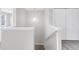 Upstairs hallway featuring modern pendant light, closet and carpeted floor at 186 S 45Th Ave, Brighton, CO 80601