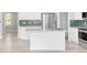 Bright kitchen with white cabinets, stainless steel appliances, and a stylish backsplash at 186 S 45Th Ave, Brighton, CO 80601
