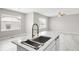 Open-concept kitchen island featuring a sink with a modern faucet at 186 S 45Th Ave, Brighton, CO 80601