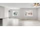 Bright, open-plan living room with modern lighting, large windows, and light wood-look floors at 186 S 45Th Ave, Brighton, CO 80601