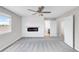 The main bedroom includes an electric fireplace, large window, and a stylish ceiling fan at 186 S 45Th Ave, Brighton, CO 80601