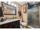 Modern bathroom featuring a black vanity, framed mirror, and a glass-enclosed shower at 148 S Holman Way, Golden, CO 80401