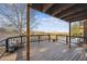 View of an empty deck with bare trees, string lights and a wood plank floor on a partially cloudy day at 148 S Holman Way, Golden, CO 80401