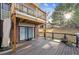 Wooden deck with railing overlooks yard. Features include sliding glass door and storage underneath at 148 S Holman Way, Golden, CO 80401