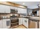 Well-designed kitchen showcases stainless steel appliances, granite countertops, and mosaic tile backsplash at 148 S Holman Way, Golden, CO 80401