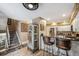 View of a modern kitchen with a granite countertop, a stainless steel refrigerator, and wooden floors at 148 S Holman Way, Golden, CO 80401