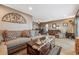 View of a spacious living room with a large couch, a coffee table, and hardwood floors at 148 S Holman Way, Golden, CO 80401