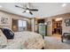 Well-lit bedroom with a large window, dresser, and a view into a walk-in closet at 148 S Holman Way, Golden, CO 80401