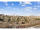 Scenic view of neighborhood featuring homes nestled among trees with a blue sky and scattered clouds at 148 S Holman Way, Golden, CO 80401