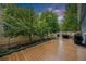 Backyard deck with string lights overhead featuring trees and shrubbery along the side of the house at 12951 Vallejo Cir, Denver, CO 80234