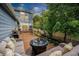Backyard deck with plush seating, a grill and fire pit, all with decorative string lights overhead at 12951 Vallejo Cir, Denver, CO 80234