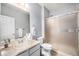 This bathroom features a shower and a sink with light tan countertops and is painted in light grey at 12951 Vallejo Cir, Denver, CO 80234