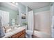 Well-lit bathroom features a vanity, tiled shower, and fresh neutral color palette at 12951 Vallejo Cir, Denver, CO 80234