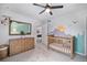 Charming Bedroom showcasing mountain mural, stylish crib, and wood dresser for a cozy, playful space at 12951 Vallejo Cir, Denver, CO 80234